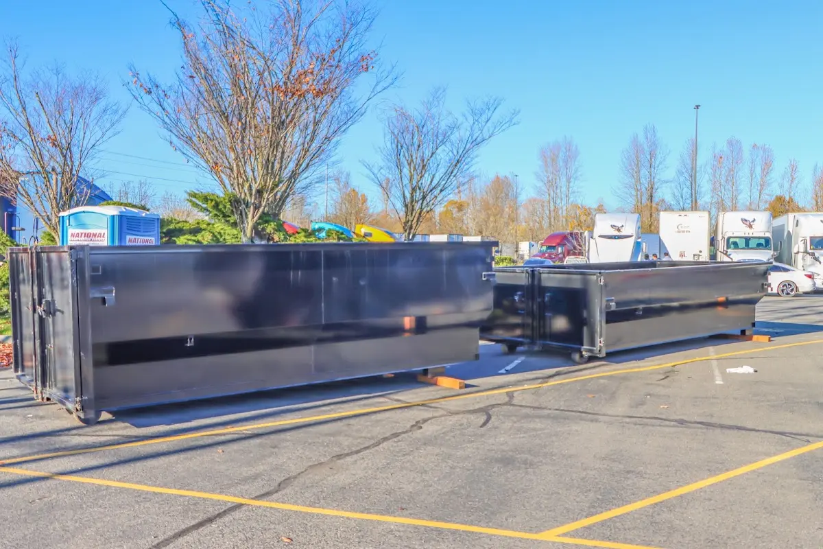 Professional dumpster rental service with roll-off container on residential driveway in Milo